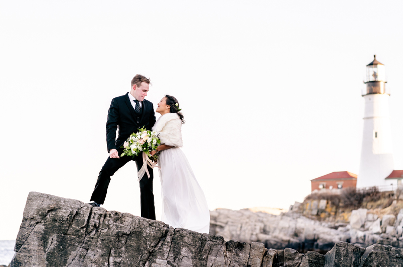 Portland Head Light Is The Ultimate Backdrop For A Seasonal Coastal Maine Elopement Bride And Groom On A Cliff