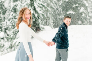Snowy Hometown Engagement In Snoqualime Pass Washington Holding Hands And Walking In The Snow