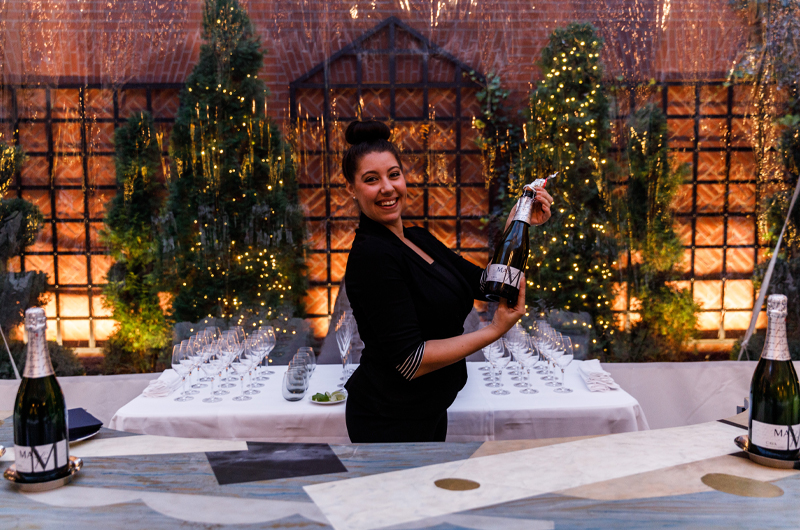 The Ivy Hotels Winter Garden Is A Romantic Haven For Baltimore Weddings & Private Parties Caterer Showing Off Champagne Bottle