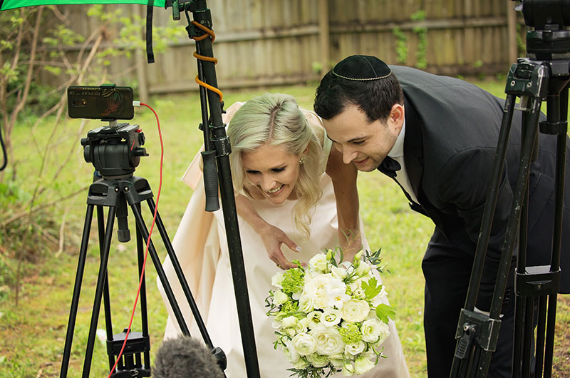 Memphis Chef Josh Steiner & Marketing Director Wallis Tosi’s Virtual At Home “I Do” Is Beyond Adorable Couple Looking At Pictures (1)