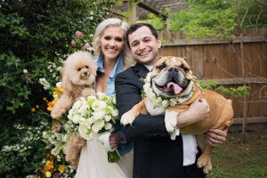 Wallis And Josh Couple Holding Dogs