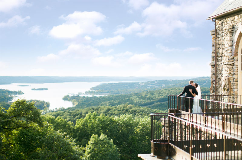 Escape To Connect Amongst Nature At Big Cedar Lodge Bride And Groom Kissing On Balcony Overlooking Nature