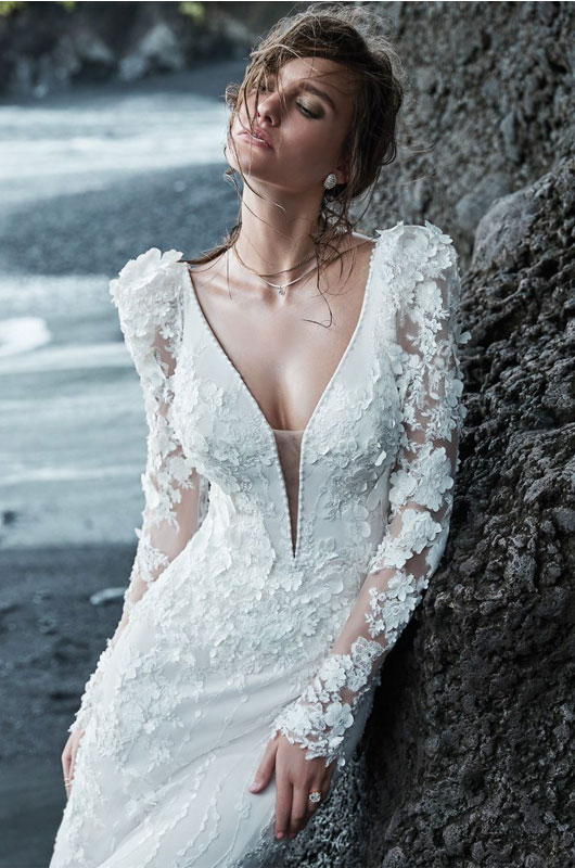 Leading Bridal Boutique Ivory And Beau Shares Wedding Gown Trends For 2021 Model Leaning Against Rock