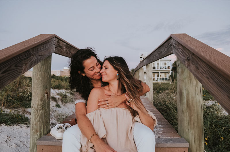 St Petersburg Florida Staycation Ends In Blissful Beachside Proposal Couple Holding Each Other On Steps