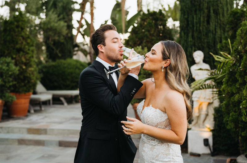 Celebrity Couple Alex Hall And Brianna Hugans Glamorous California Elopement Couple Sipping Champagne