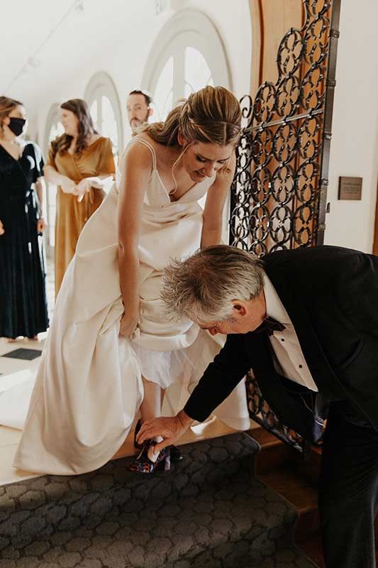 Ten Lighthearted Wedding Observations From The Father Of The Bride Fixing Bride's Shoes