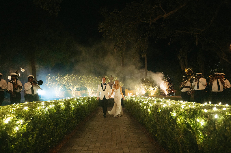 Stacey Asaro And Ryan Gaudet Marry At The Luxury Southern Oaks New Orleans Couple Walks Through Bushes While Band Is Playing Copy 2