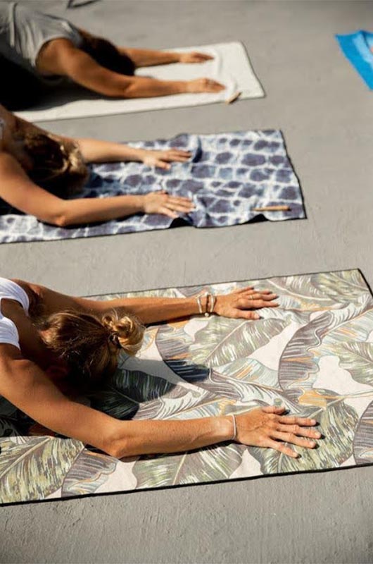 The Top Travel Must Haves For All Of Your Wedding Related Vacays Women Doing Yoga On Towels Copy