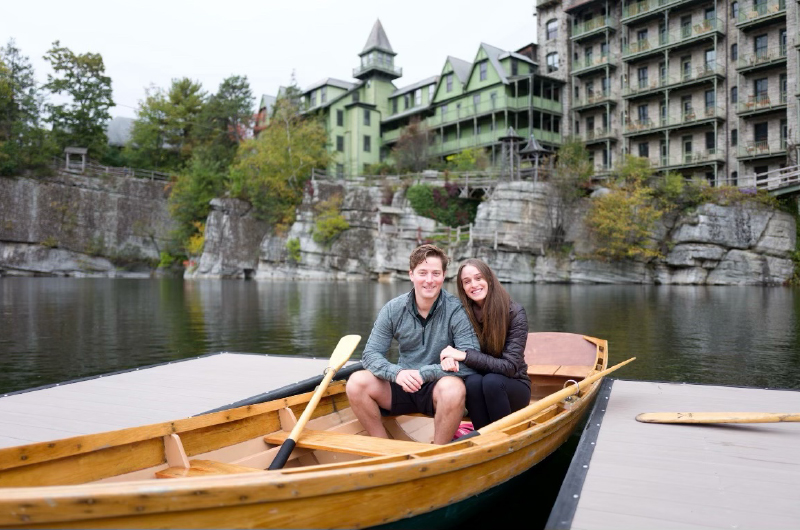 Romantic Engagement That Took Place Back Where This Story Began Image 2 Couple Smiling In Kayak Together In Front Of Buildings Copy