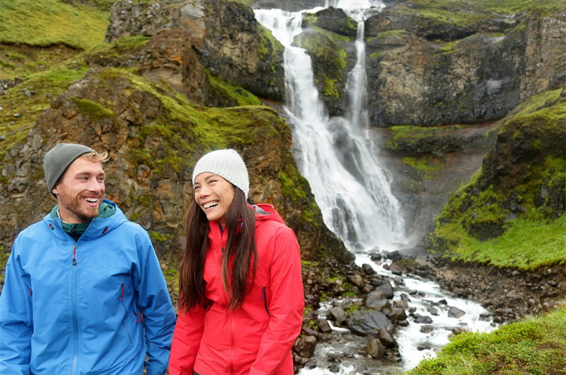 You Cant Figure Out What Type Of Honeymoon Couple You Are Couple Smiling In Front Of Waterfall Copy