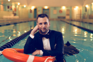 Wedding Stylist Grant McNamara Helps Brides And Grooms Celebrate In Style Closeup Of Grant On Floatie In Pool