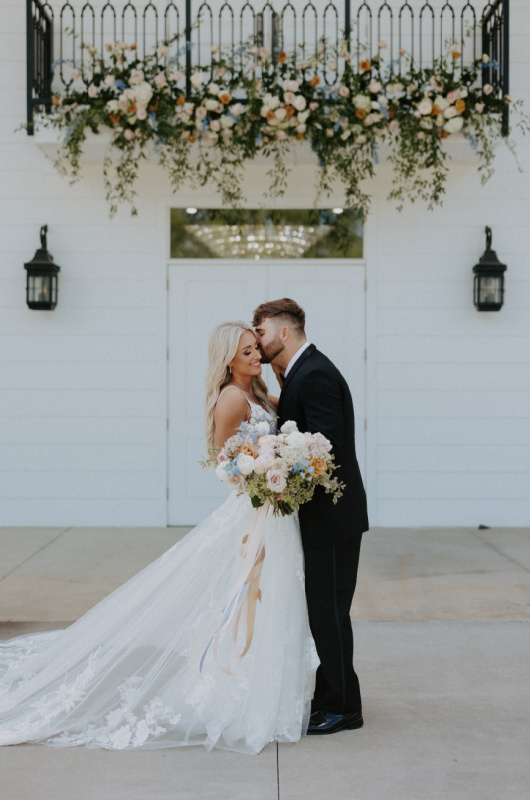Paula and Ayson Marry in a Whimsical Wedding at Legacy Acres Arkansas Groom Kissing Bride