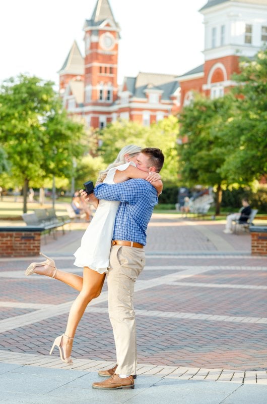 kayla and stuarts engagement at their alma mater hug