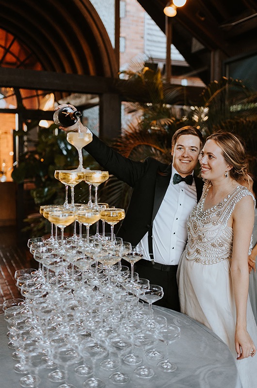 emily and matt marry in a classic church ceremony with a vintage reception champagne tower