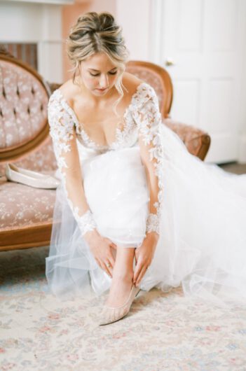 Alex Peele and Michael Oates Wedding in Brentwood Tennessee Putting in Earrings Alex Peele and Michael Oates Wedding in Brentwood Tennessee Bride Shoe