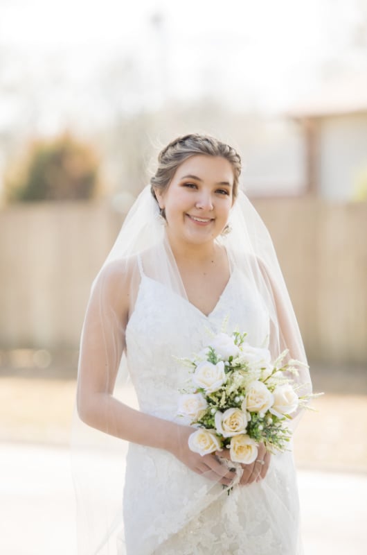 Emma Hughes And Kevin Hauman bride with veil and flowers