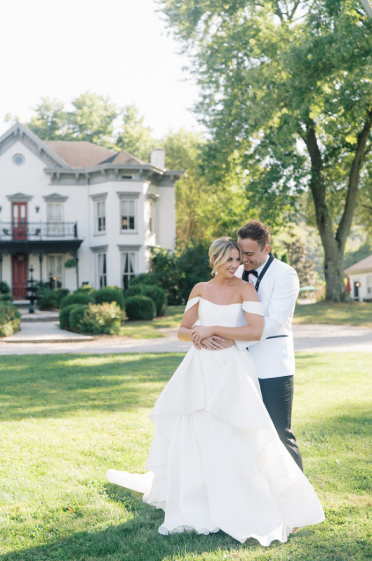 Ralph Lauren Inspired Autumnal Editorial Nestled In The Hills of Northern Kentucky bride and groom hug in front of house