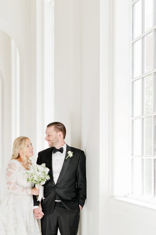 Mary Katherine Harris and James Rose Real Weddings bride and groom by window smiling at each other Mary Katherine Harris and James Rose Real Weddings bride and groom by window smiling at each other