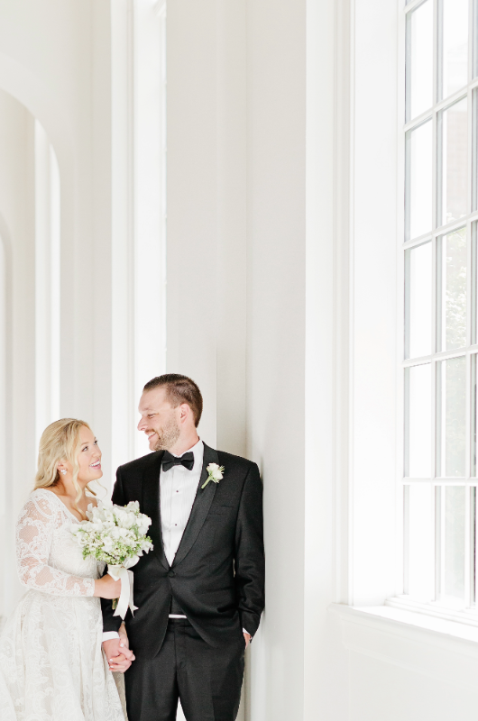 Mary Katherine Harris and James Rose Real Weddings bride and groom by window smiling at each other