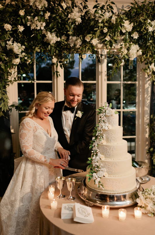 Mary Katherine Harris and James Rose Real Weddings bride and groom cut the cake