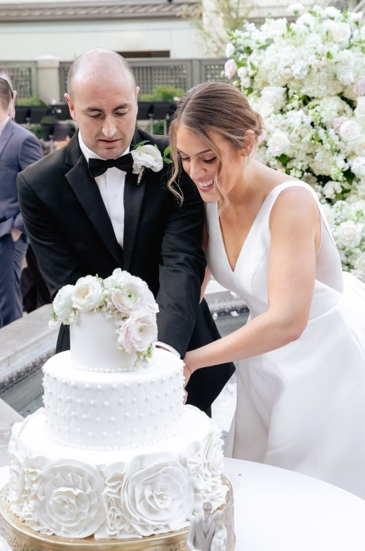 Paige Trauth And Taylor Hover cutting the cake