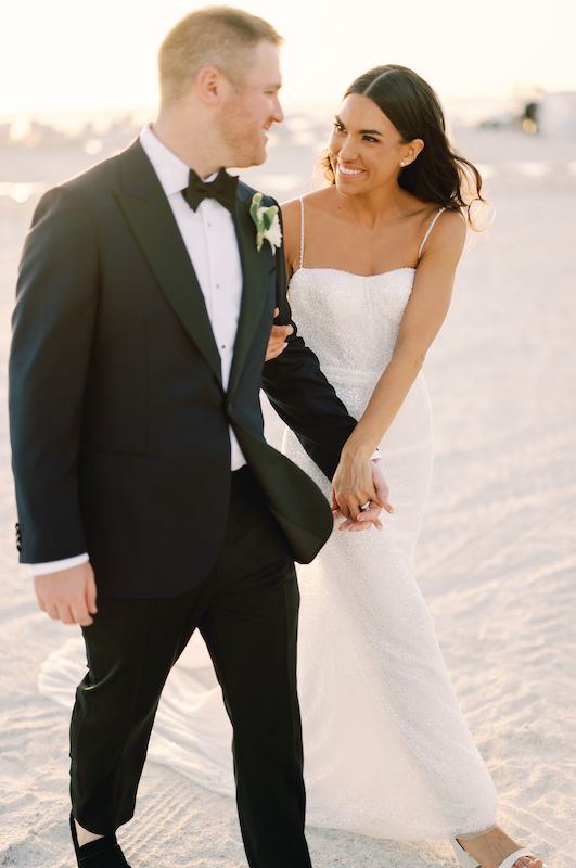 Taylor and Chris Wed Along Florida Gulf Coast at The Ritz Carlton Sarasota Bride and Groom Walking on the Beach