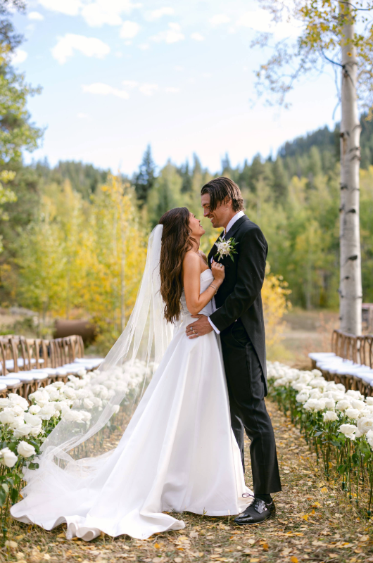 caelynn and dean real wedding bride and groom aisle holding each other