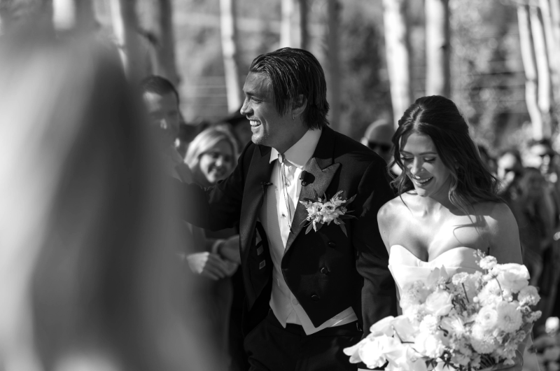 caelynn and dean real wedding bride and groom leaving aisle black and white