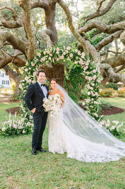 lauren milton and nicholas nicholson just married bride and groom before flower arch