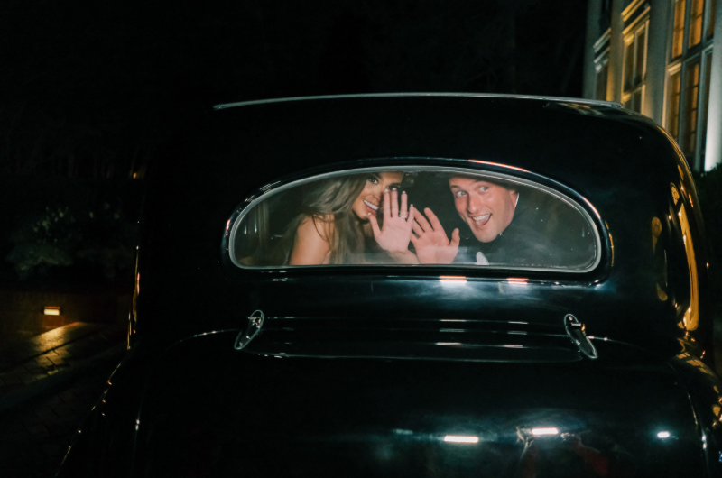 summer priester and alex hoffman real wedding smiling out of car