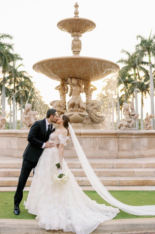 Megan Nager And Corey Turner bride and groom fountain kiss