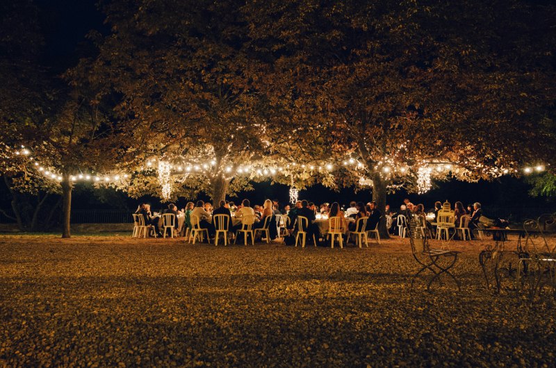 How To Transform Your Backyard Into A Stunning Wedding Venue guests in bakyard at night