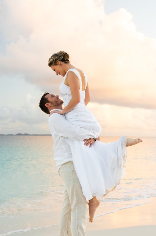 Carribbean Paradise Aurora Anguilla Resort and Golf Club couple on beach wedding lifting in air Carribbean Paradise Aurora Anguilla Resort and Golf Club couple on beach wedding lifting in air