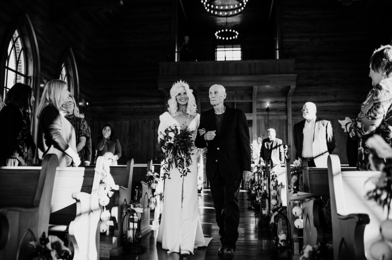 Sheila Basel & Wayne Wright real wedding bride down aisle black and white