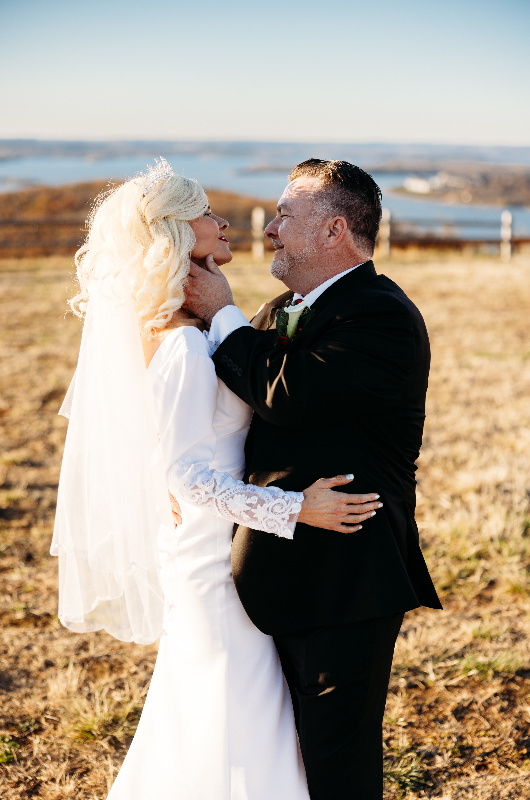 Sheila Basel & Wayne Wright real wedding couple in field Sheila Basel & Wayne Wright real wedding couple in field