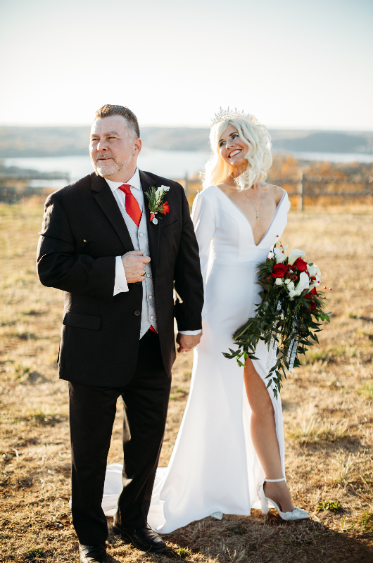 Sheila Basel & Wayne Wright real wedding couple in field Sheila Basel & Wayne Wright real wedding couple in field