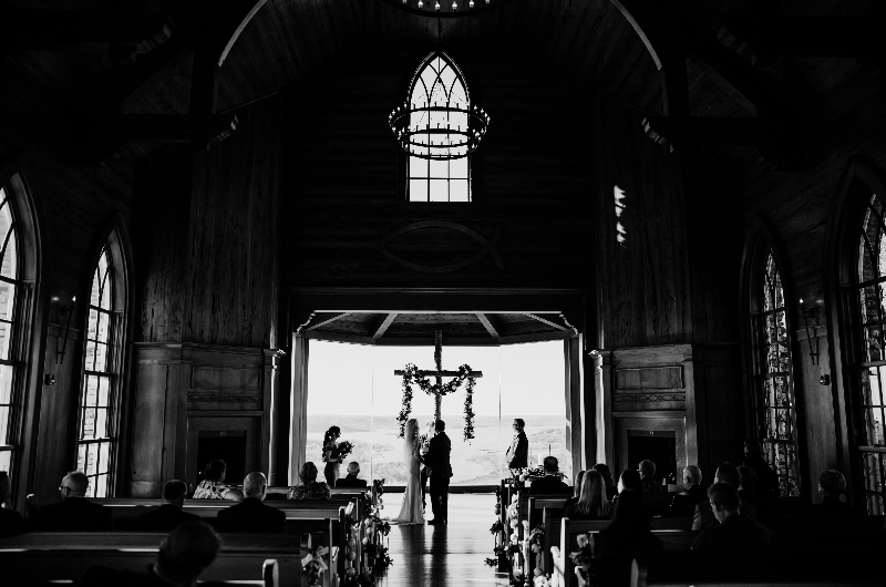 Sheila Basel & Wayne Wright real wedding venue couple at cross black and white