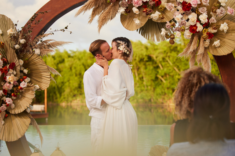 Eco Luxury fairmont mayakoba bride and groom at altar kiss