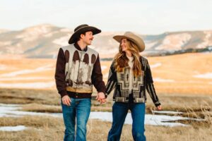 southern belle meets montana cowboy keagan carolines snowy mountain engagement walking on the ranch
