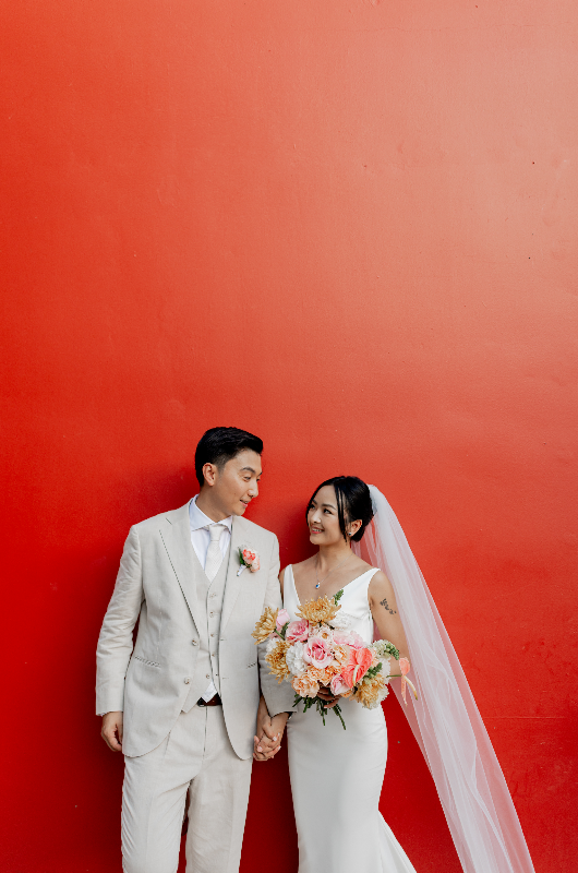 mango weddings maya riviera wedding example izzy and robert couple on red wall mango weddings maya riviera wedding example izzy and robert couple on red wall