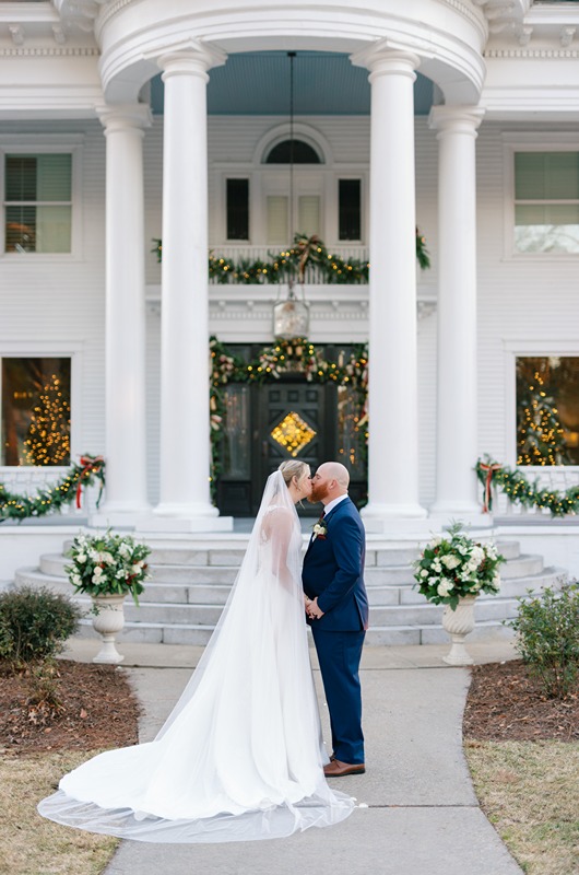 Holiday Magic Christmas Real Weddings Design Inspiration zoos wedding couple in front of the house