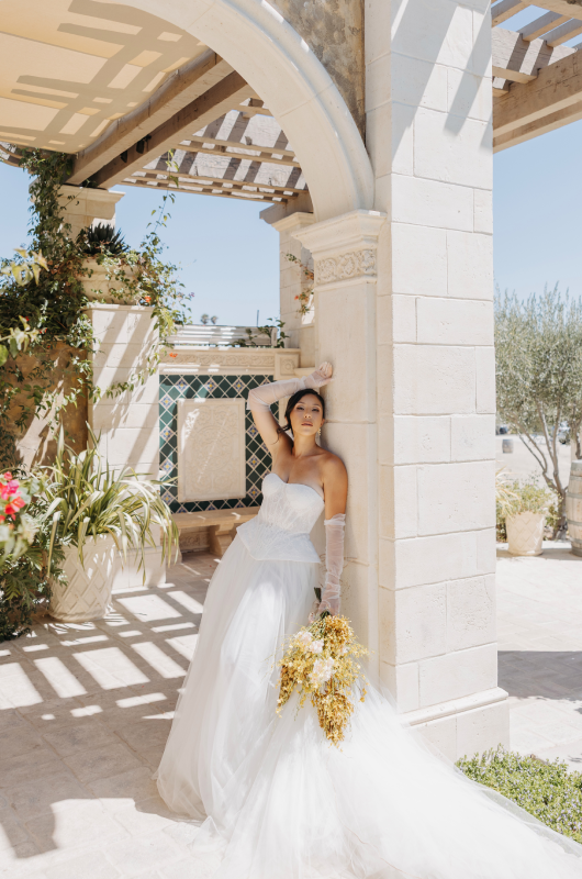 jc designs weddings and events wins best design award the styled challenge temecula ca bride leaning on an arch