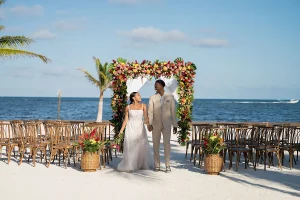 Alaia Events Designs The Alaia Beach The Styled Challenge San Pedro Belize beach wedding happy couple floral arch ocean joyous Alaia Danielle Brown Photography