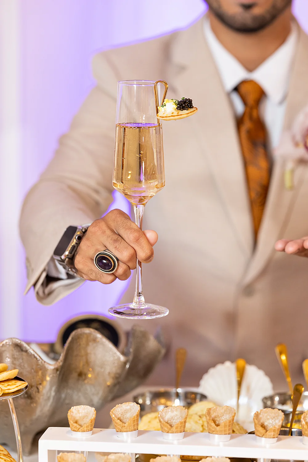 Mod Events Designs Eau Palm Beach man holding champagne appetizer Sia Weddings Photography