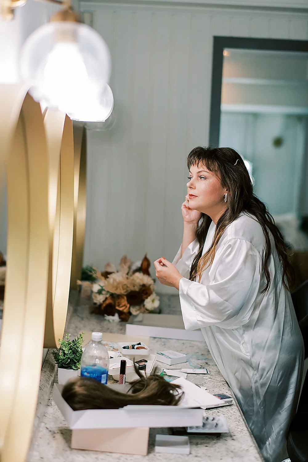 Christina Collins And Brian Gardner woman applying makeup wedding day getting ready North Carolina Meghan Rose Photography