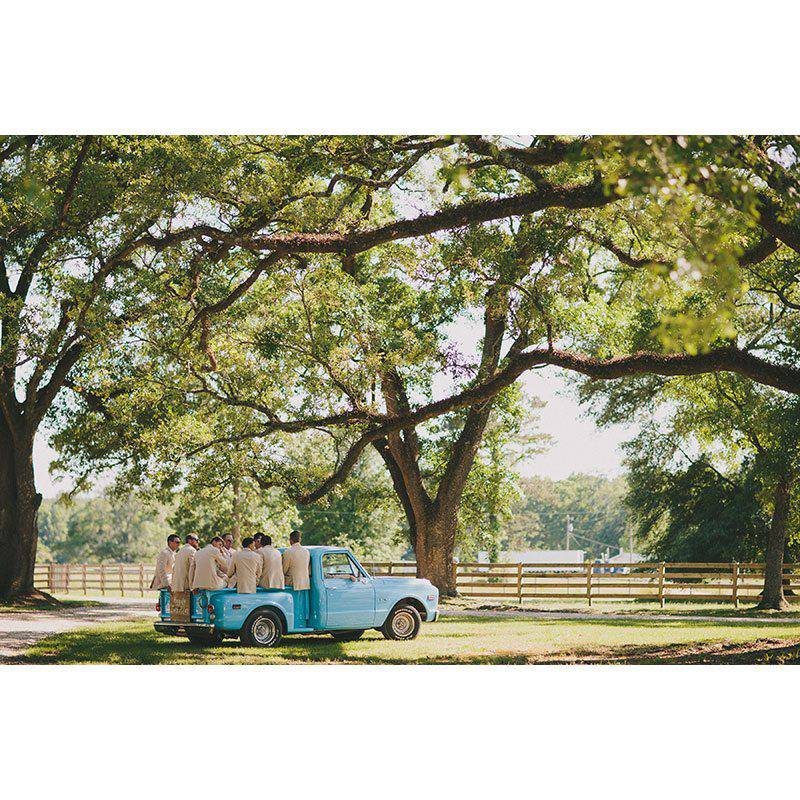 The White Magnolia groomsmen in classic blue truck