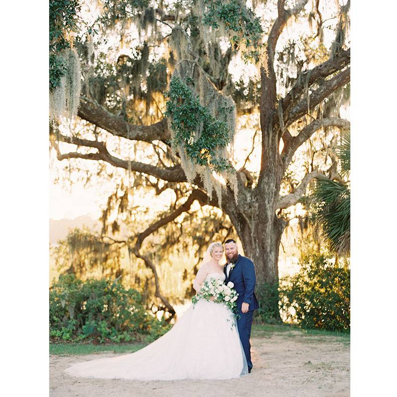 Xanna Garner and Travis Bailey by cypress tree