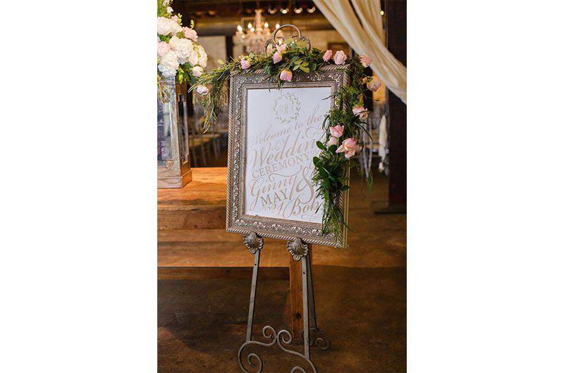 Signature Occasions wedding sign with pink roses and greenery