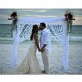 Elegant Beginnings Weddings and Events couple kissing beach wedding ceremony