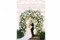 Bride and Groom At Heartwood Hall under white rose arch